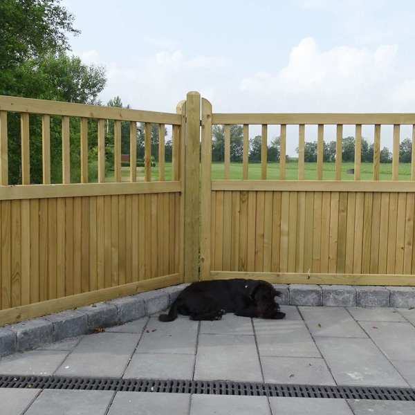 En hund tager en middagslur foran et Country Garden hegn