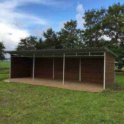 Et læskur står midt i en dyrefold.