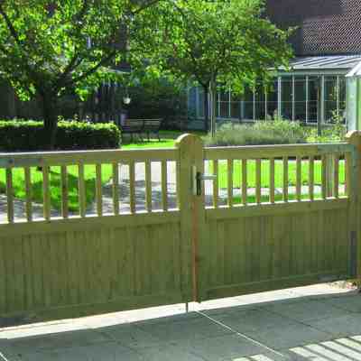 I forgrunden er en Country Garden i baggrunden er en have med et drivhus