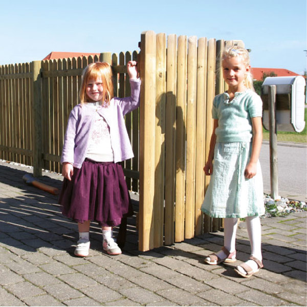 I en indkørsel står to piger op ad et Terndrup stakit